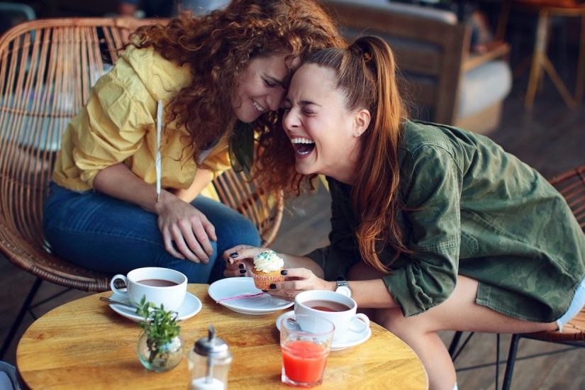 Two-women-laughing-at-coffee-shop-1500x825