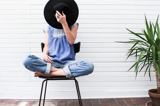 woman sitting on chair with legs crossed