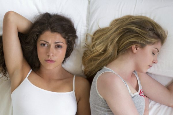 2 women lying in bed