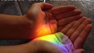 2 hands holding rainbow lights