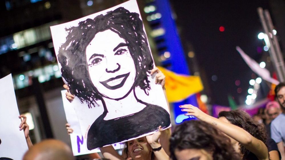 Demonstrator hold drawing of Marielle Franco Face