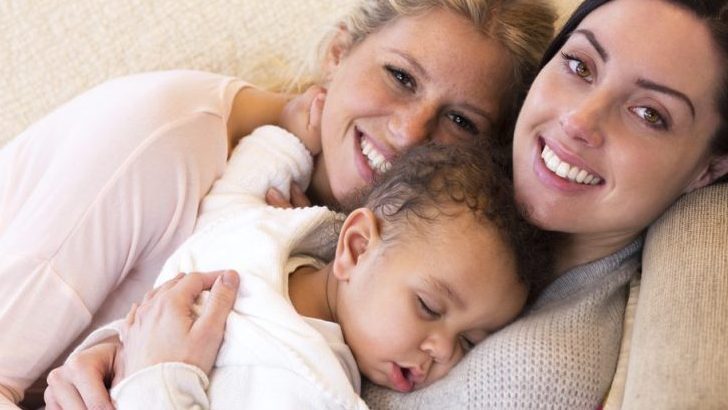 lesbian parents on lounge with baby