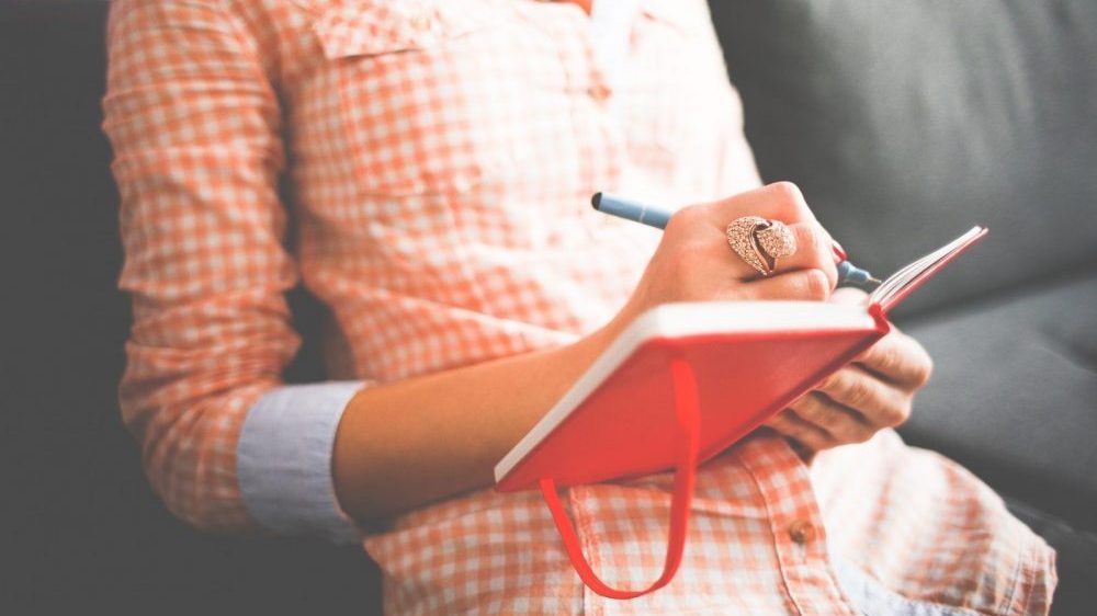 woman writing in a diary