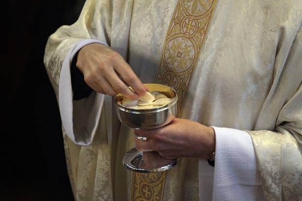 Catholic Priest performing the holy sacrament