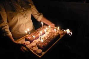 Woman holding tray with Birthday cupcakes