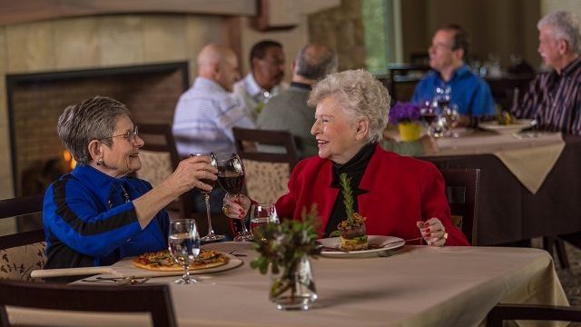 2 older women enjoying dinner