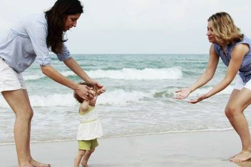 Lesbian Couple on beach with toddler