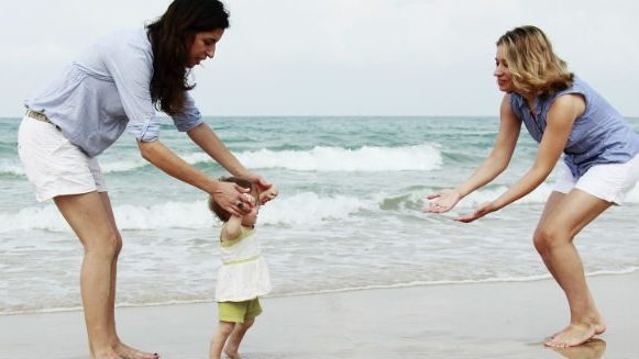 Lesbian Couple on beach with toddler