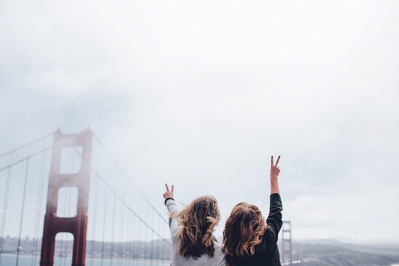 2 women in front of golden gate bridge