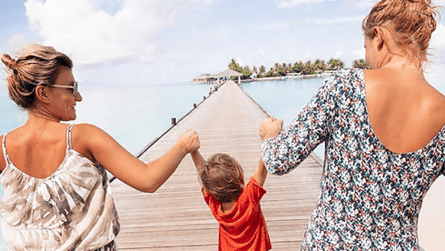 2 women walking with child