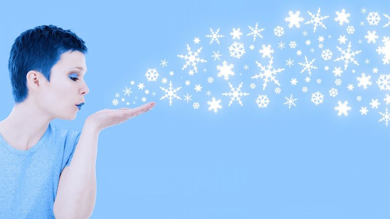 Illustration of woman blowing snowflakes