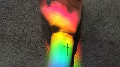 Hand and arm with Cross Tatoo