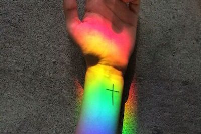 Hand and arm with Cross Tatoo