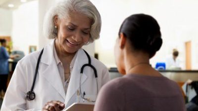 Older female doctor with younger female patient