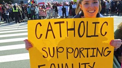 Woman holds Marriage Equality for Catholics sign