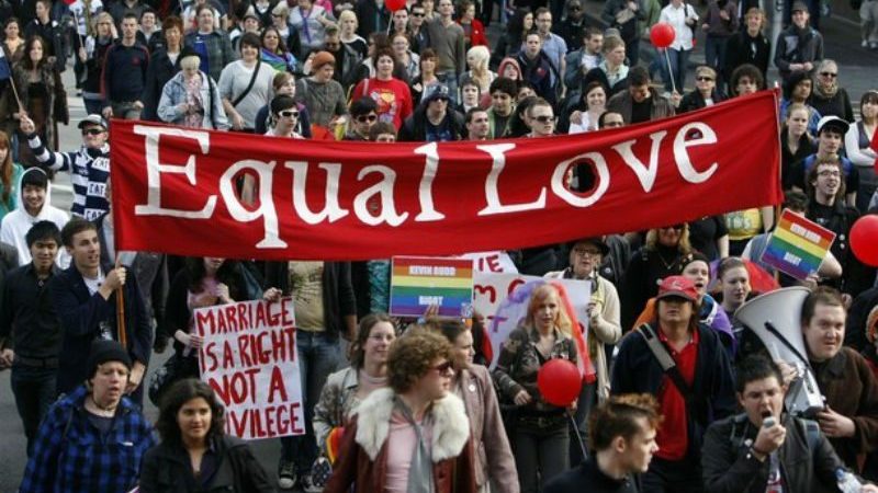 Marriage Equality Protester carrying an Equal Love banner