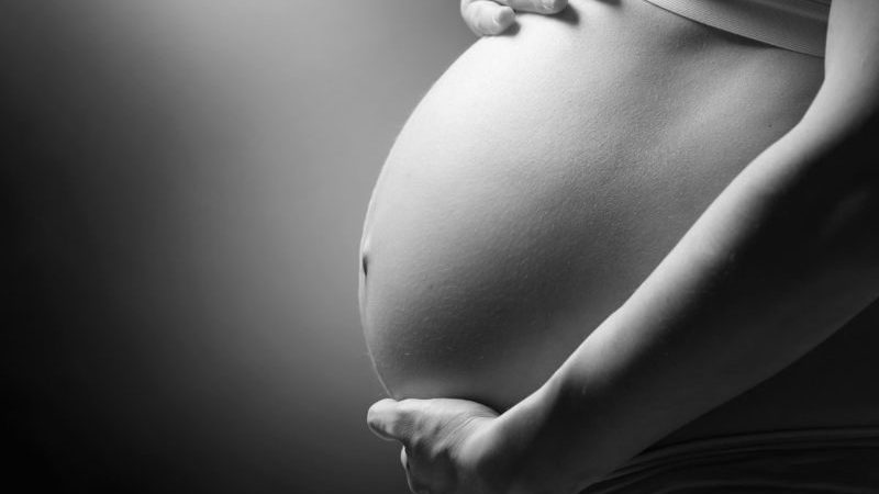 black and white photo of pregnant woman