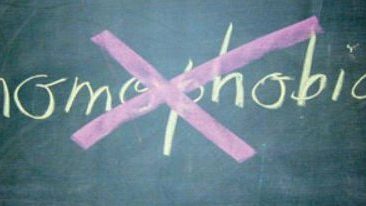 homophobia written on a blackboard