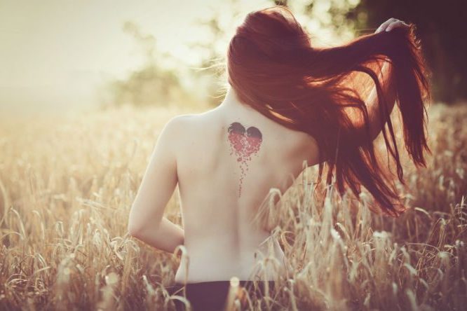 women in corn field from behind